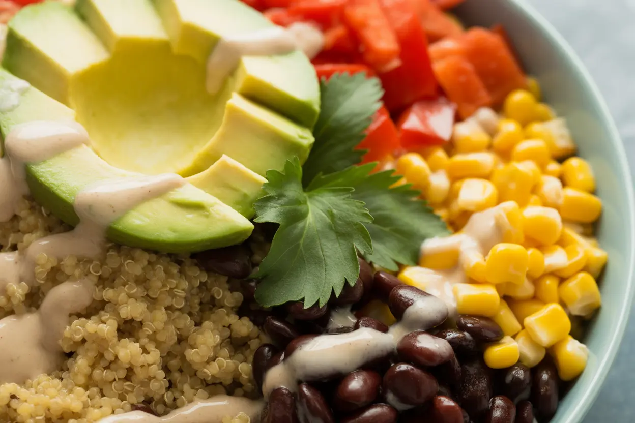 A colorful and appetizing gluten-free quinoa bowl with black beans, corn, and avocado.