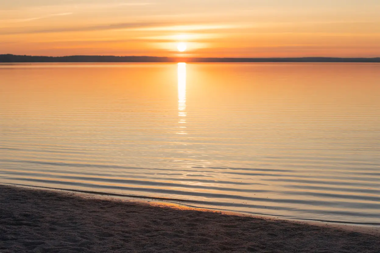 A hopeful sunrise over a calm Indiana lake, symbolizing a new beginning and the start of a recovery journey.