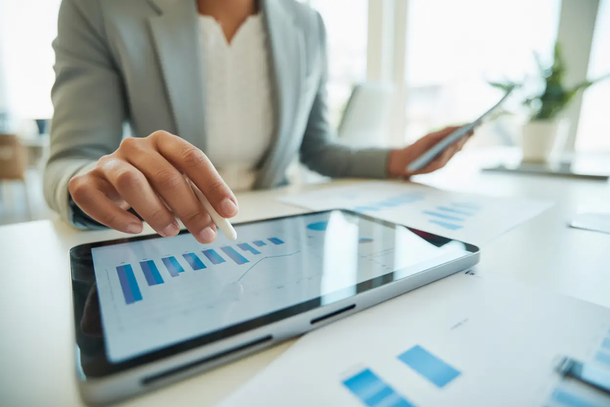 A professional reviewing charts on a tablet in a modern office, representing evidence-based practice.
